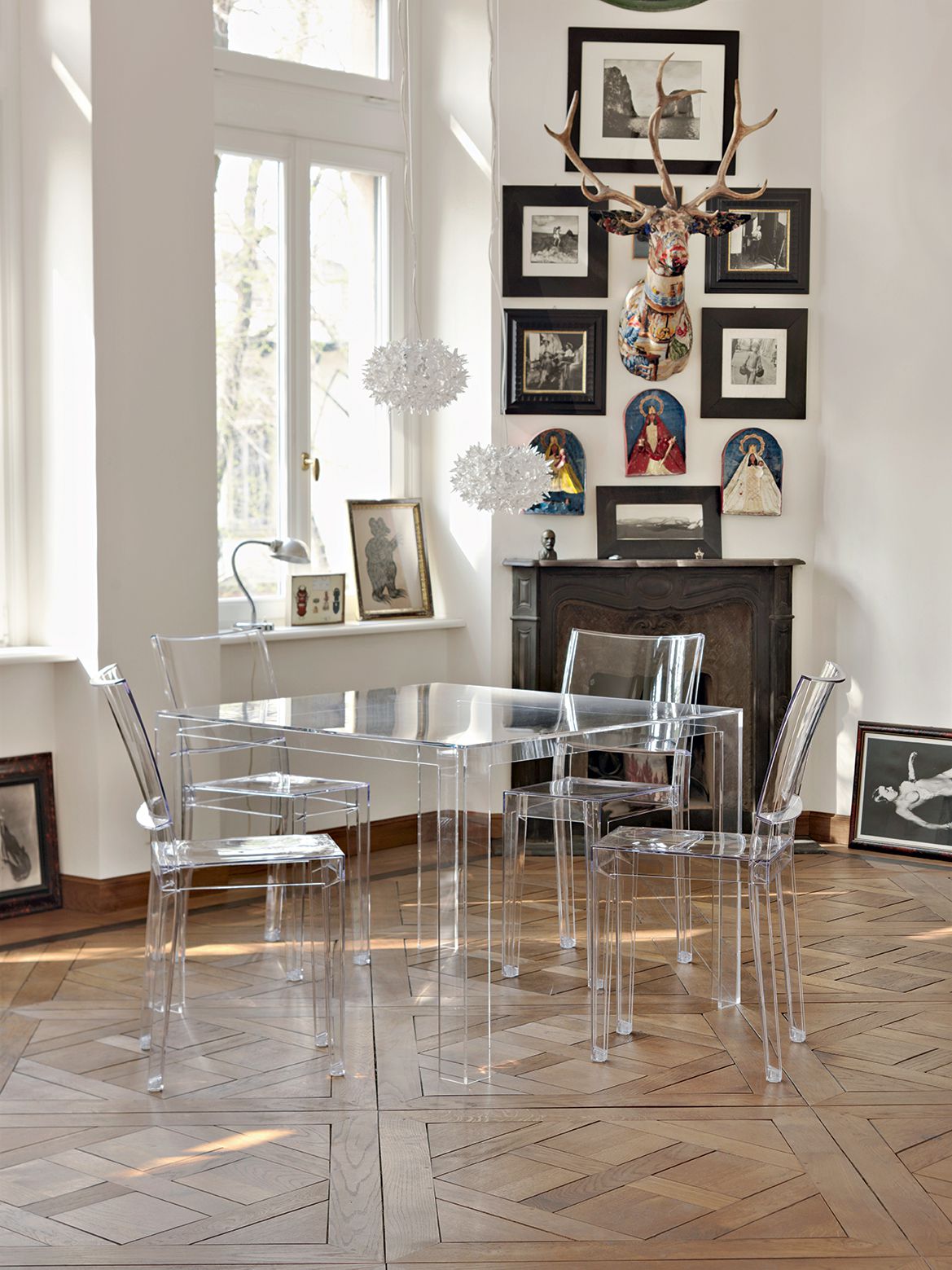 Esszimmer mit transparentem Tisch und vier La Marie Stühlen von Kartell, modernes Möbeldesign.