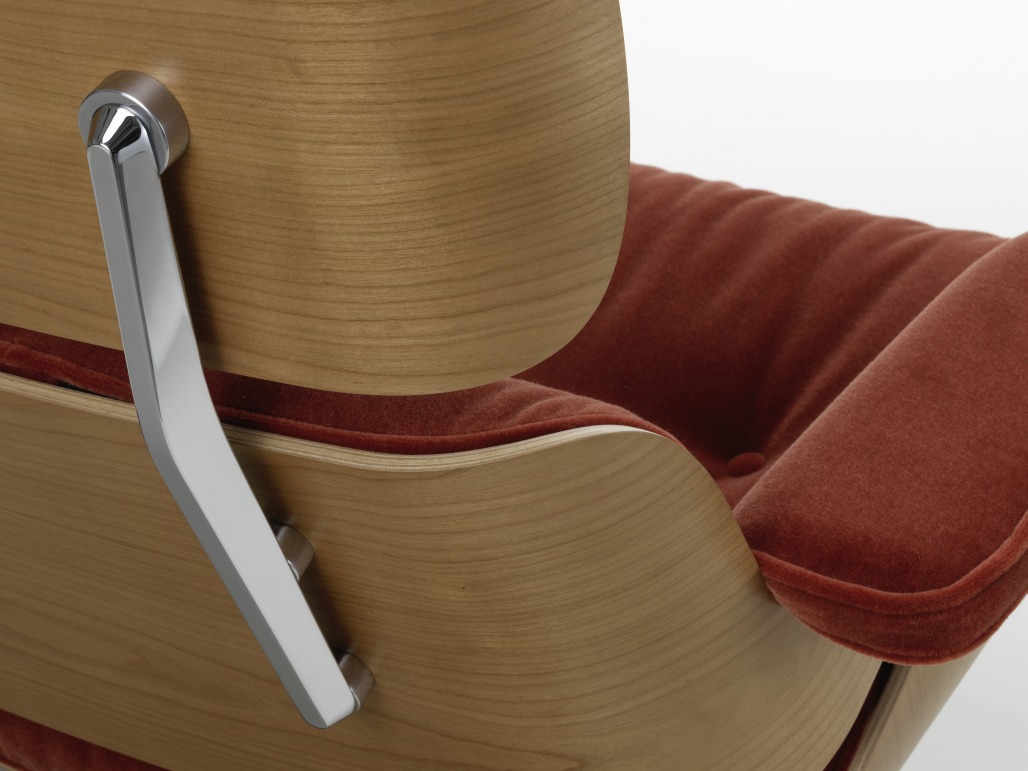 Detailaufnahme: Eames Lounge Chair Sessel mit Holzrahmen und rotem Samtbezug, Designklassiker für Wohnzimmer.
