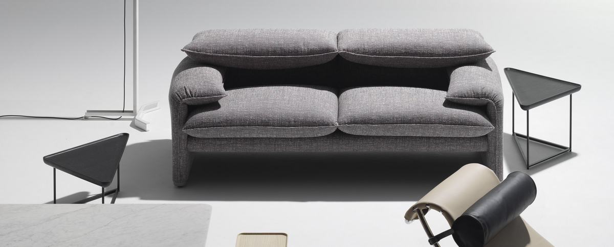 Graues Cassina Maralunga Sofa, Zweisitzer, modernes Design mit bequemen Kissen und minimalistischen Beistelltischen.