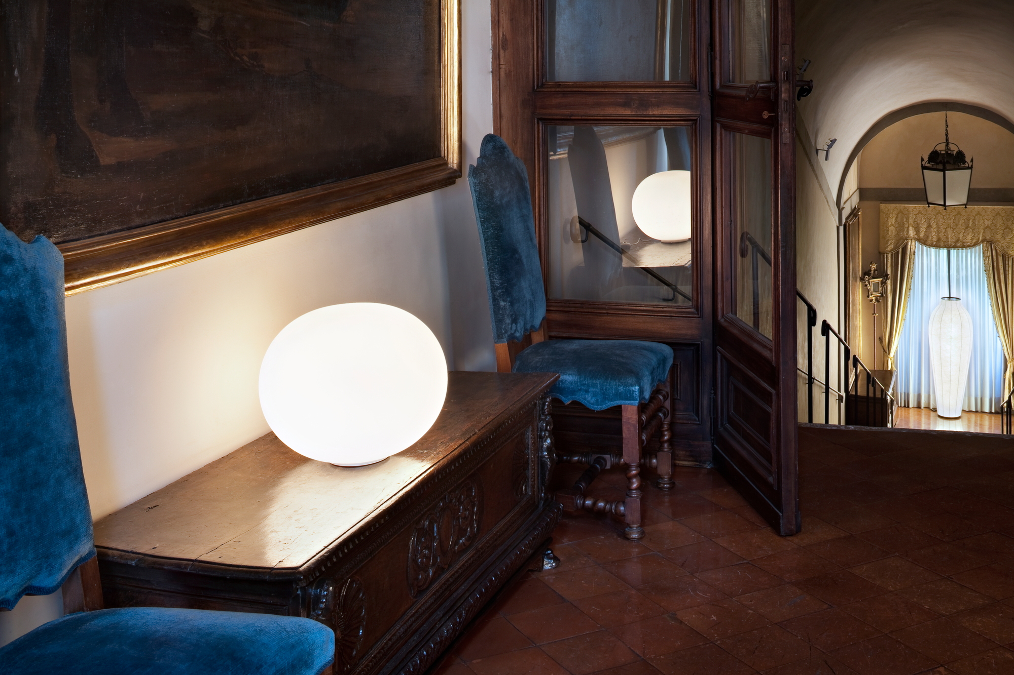 Glo Ball Tischleuchte von Flos, runde Lampe auf Kommode, warmes Licht, modernes Design.