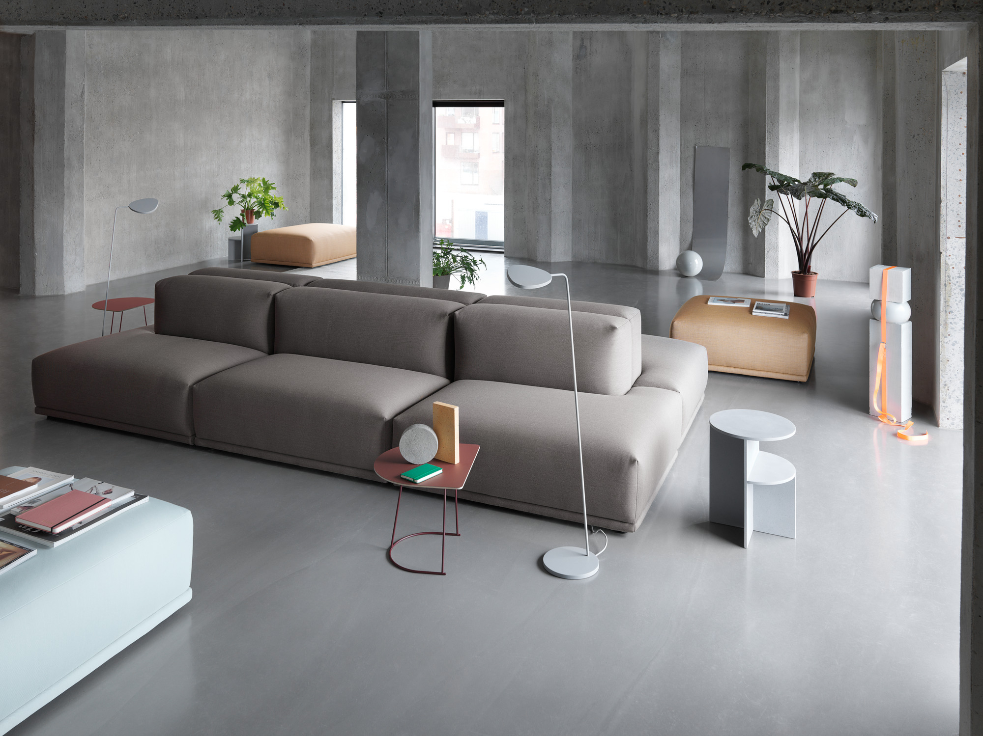 Moderner Wohnraum mit grauem Sofa und Muuto Airy Coffee Table Beistelltischen in Rot und Weiß.