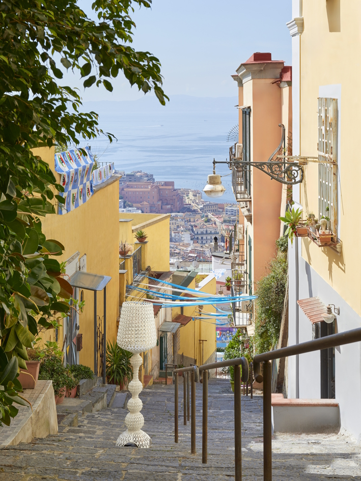 Weiße Design Stehleuchte auf Treppe in Italien mit Blick auf das Meer, dekorative Lampe für Innen und Außen.