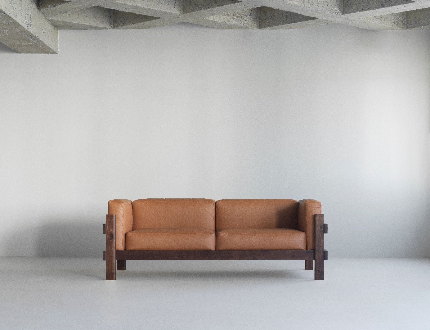 Kube Sofa von Normann Copenhagen, braunes Ledersofa mit dunklem Holzrahmen im minimalistischen Raum.