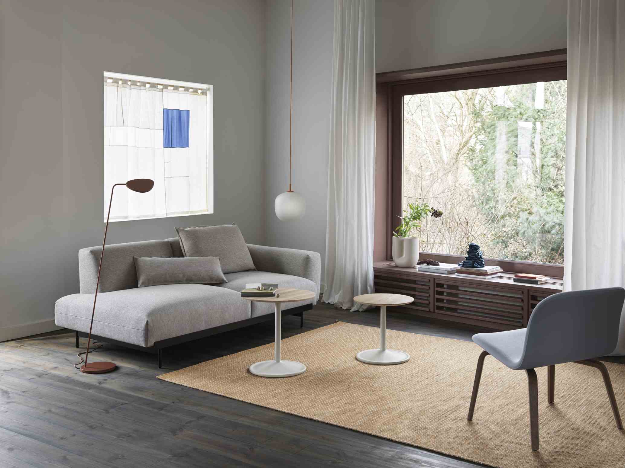 Heller Wohnraum mit Sofa, Stuhl, Lampe und zwei Muuto Soft Side Table Beistelltischen mit Holzplatte und weißem Fuß.