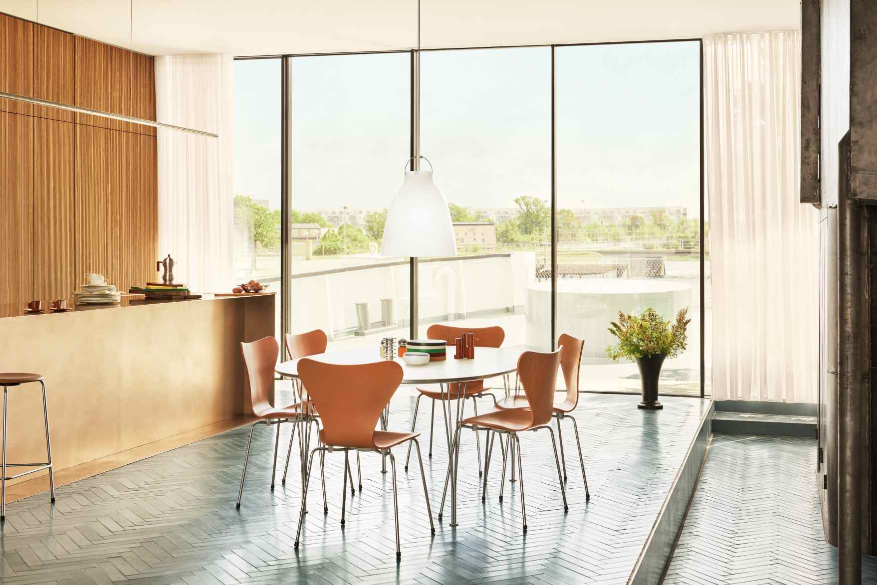 Esszimmer mit Super Elliptisch Tisch von Fritz Hansen und Serie 7 Stühlen in hellem, modernem Ambiente.