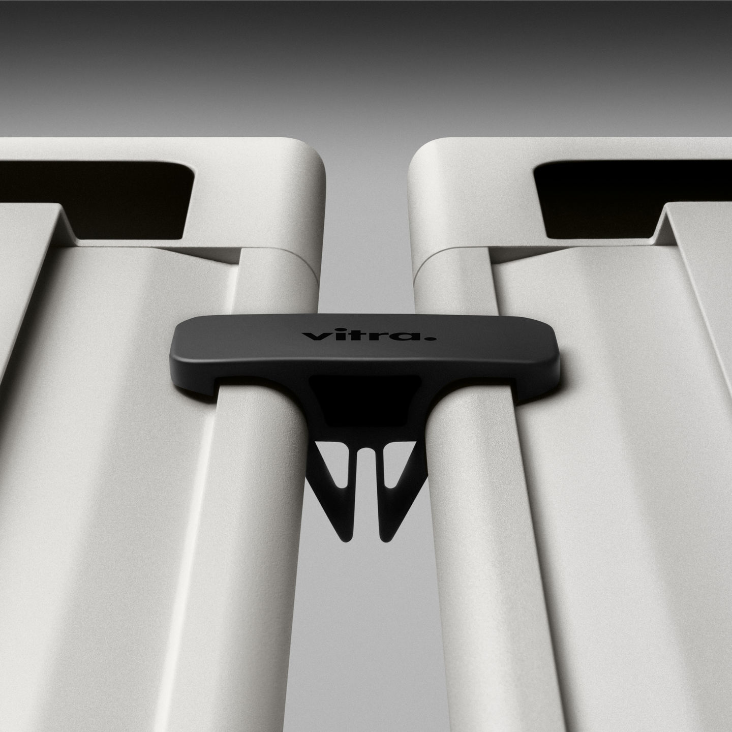 Detailaufnahme des Vitra Anagram Plattformverbinders, der zwei weiße Elemente zusammenhält, ideal für modulare Möbel und Büroausstattung.