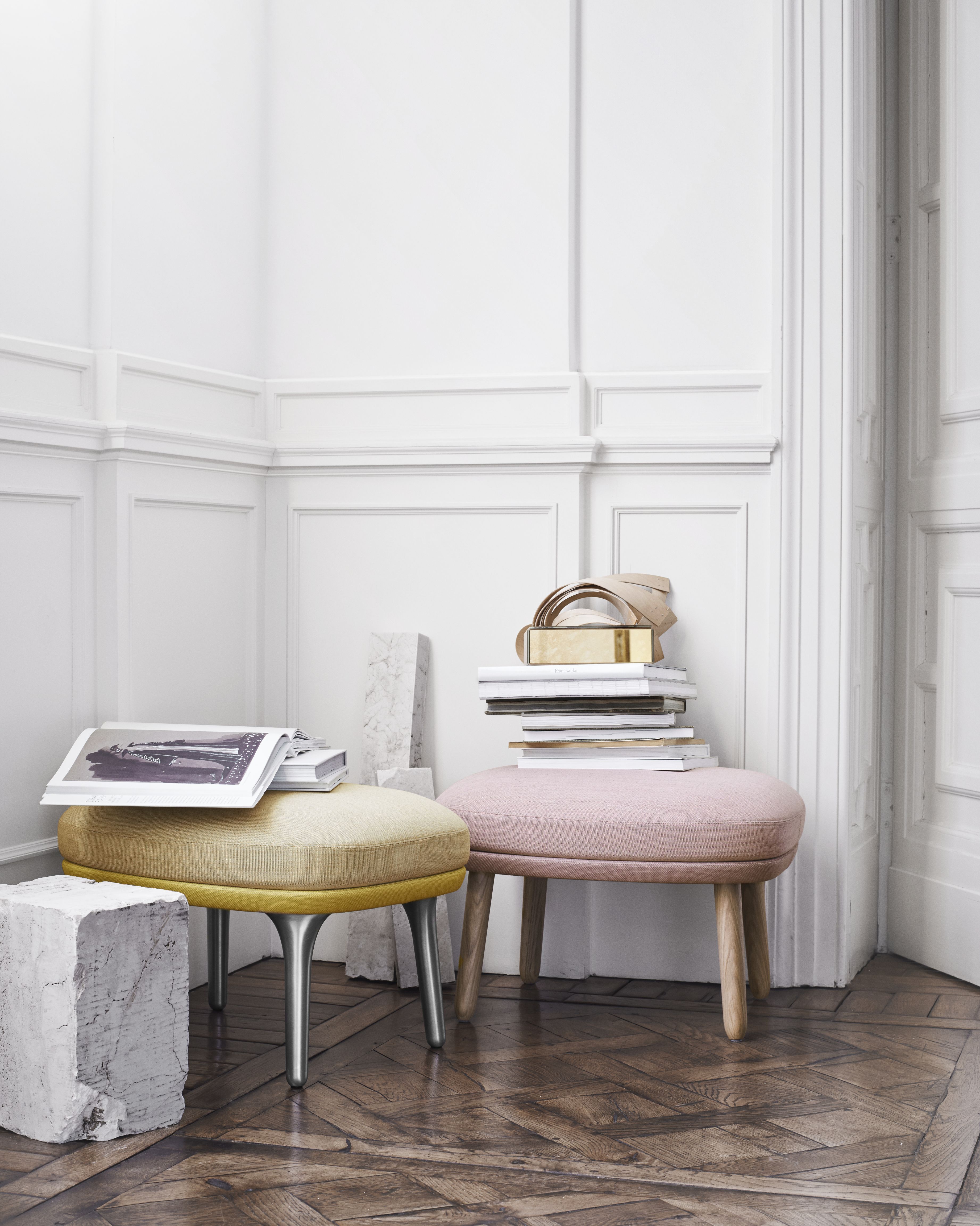 Zwei Ro Sessel von Fritz Hansen in Gelb und Rosa mit Büchern in einem Raum.