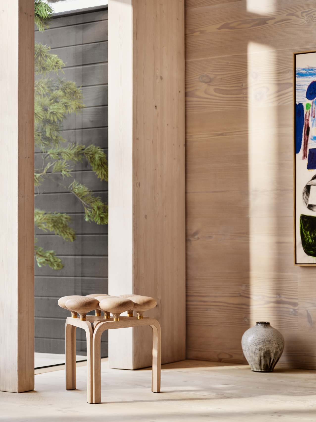Nahaufnahme des Fritz Hansen Utzon Stool Hockers aus hellem Holz in modernem Interieur.