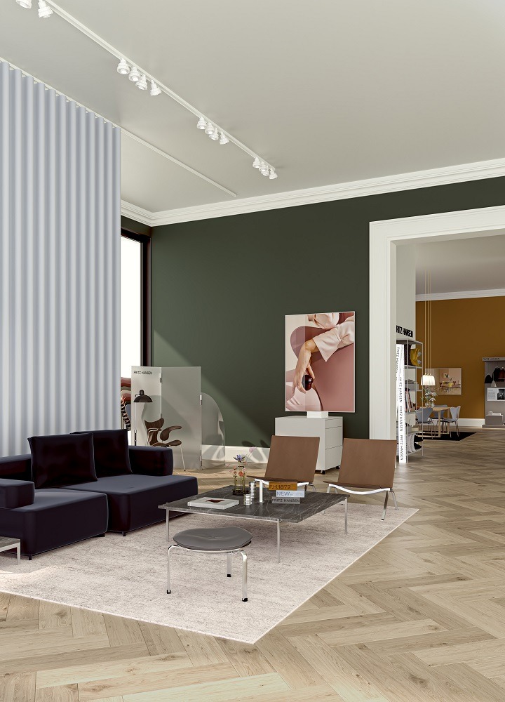 Grauer PK 33 Hocker von Fritz Hansen im modernen Wohnzimmer mit Sofa und Teppich.