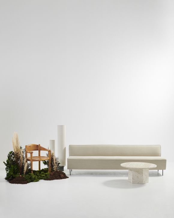 Gubi Daumiller Esszimmerstuhl aus Holz, kombiniert mit beigem Sofa und rundem Tisch.