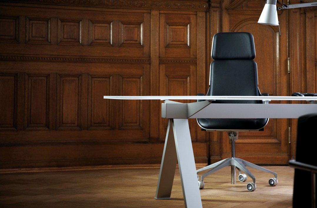 Interstuhl Silver SV11P Bürodrehstuhl hoch in Schwarz vor einer holzvertäfelten Wand und Schreibtisch.