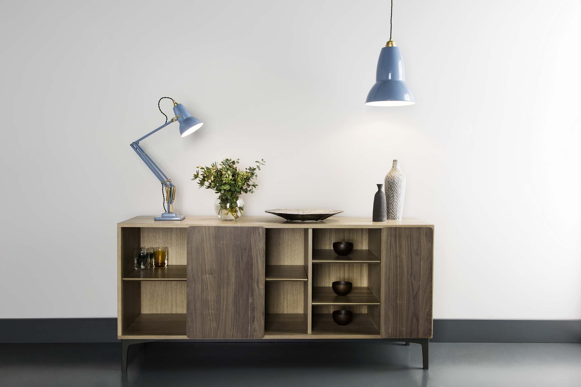 Anglepoise Original 1227 Brass Tischleuchte in Hellblau auf einem Sideboard mit Dekoration.