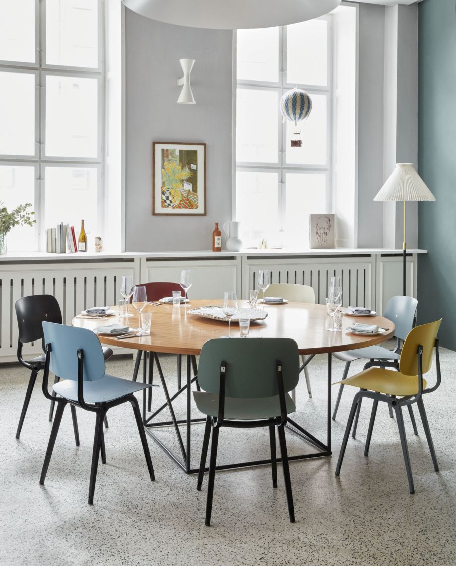 Esstisch mit farbigen Revolt Chair Stühlen von Hay, modernes Design, schwarzes Stahlgestell, verschiedene Sitzfarben.