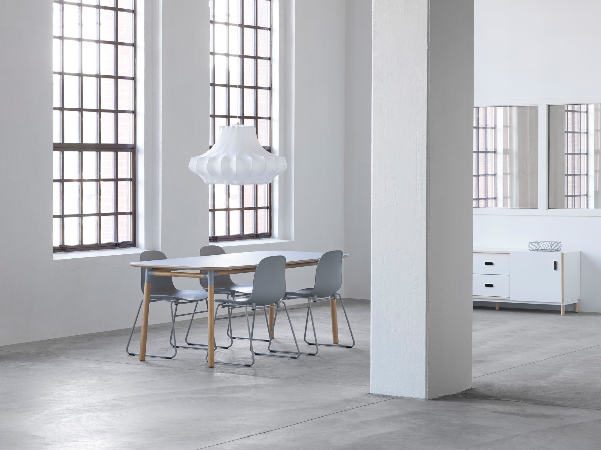 Helle Inneneinrichtung mit Esstisch, grauen Stühlen und der weißen Phantom Lampe von Normann Copenhagen.