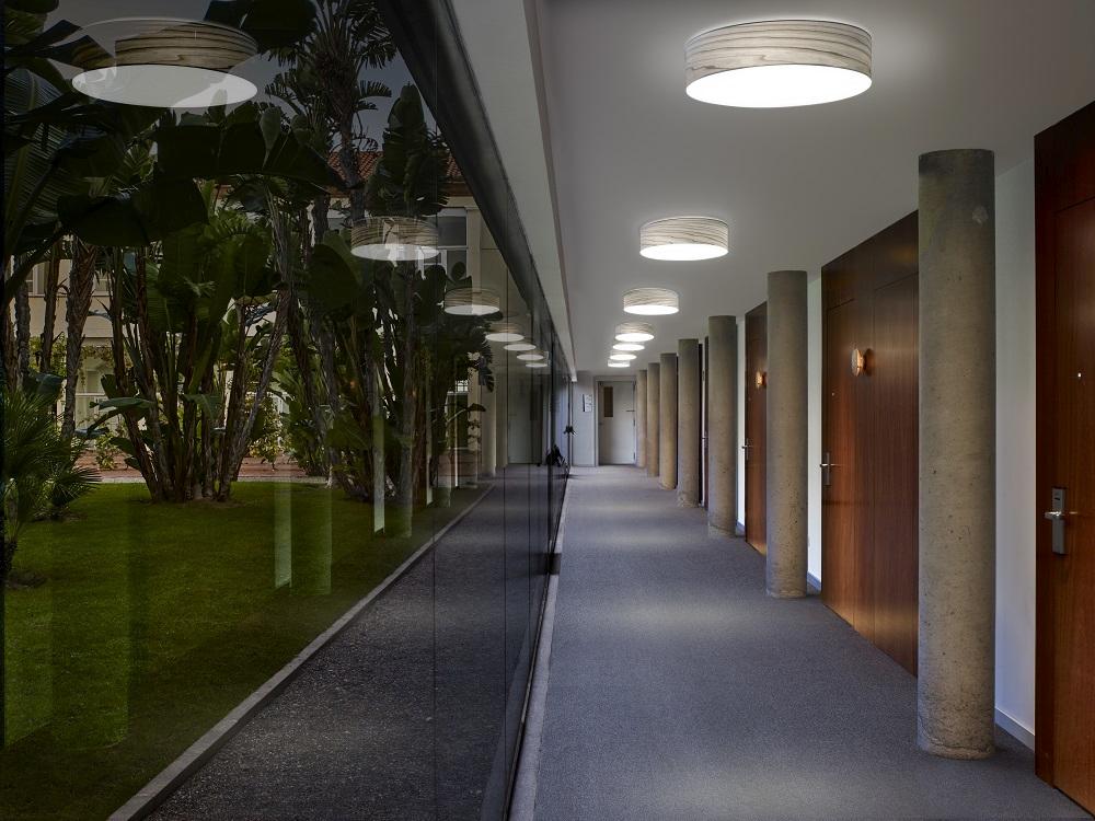 Flur mit Gea LED Deckenleuchten von LZF Lamps, moderne Innenbeleuchtung für stilvolles Ambiente.