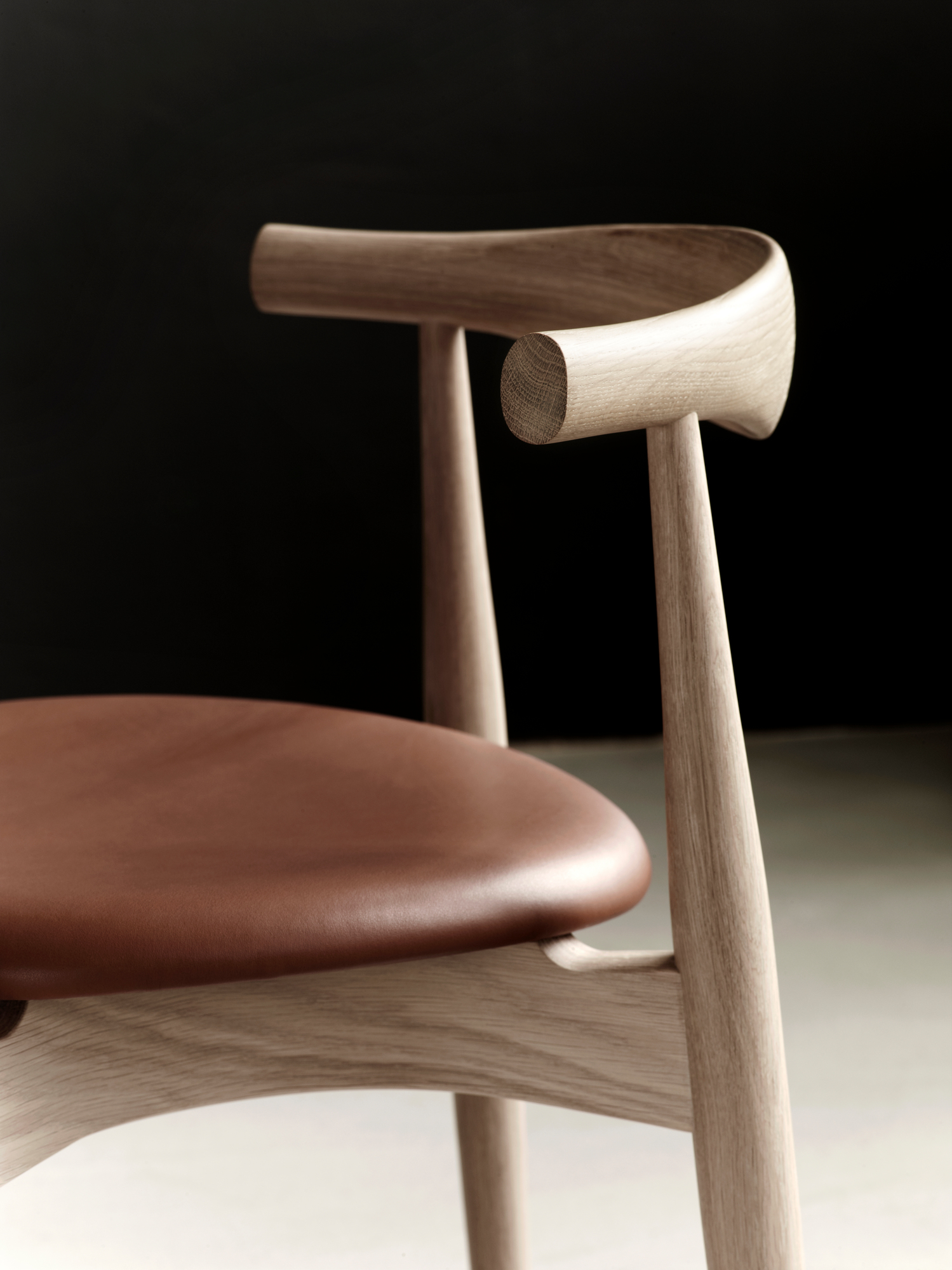 CH20 Elbow Chair Detail: Eiche Gestell, brauner Ledersitz, Design Stuhl von Carl Hansen.