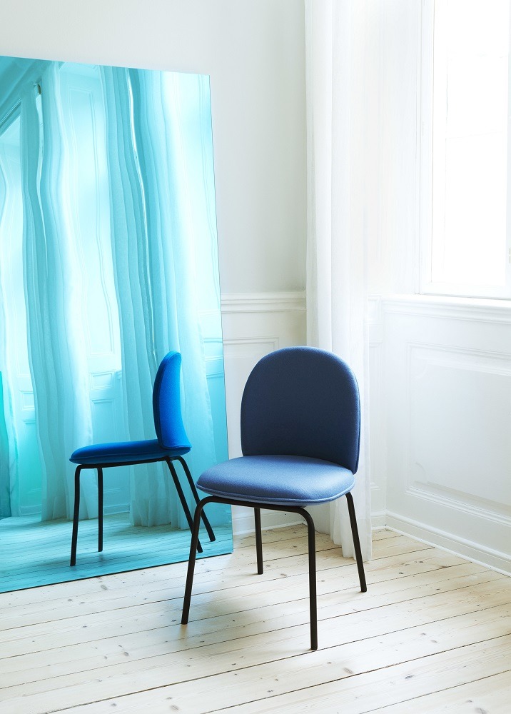Blauer Ace Chair Stuhl von Normann Copenhagen mit schwarzem Gestell vor blauem Spiegel.