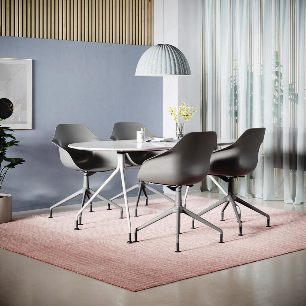Graue Yonda Universalstühle von Wilkhahn mit Viersternfuß um einen runden, weißen Tisch in modernem Ambiente.