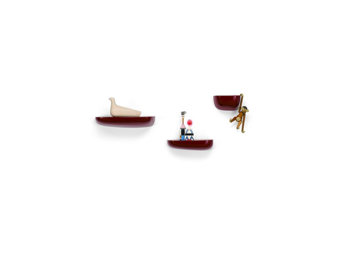 Vitra Corniches Wandboards in Rotbraun mit Deko-Objekten an einer weißen Wand.