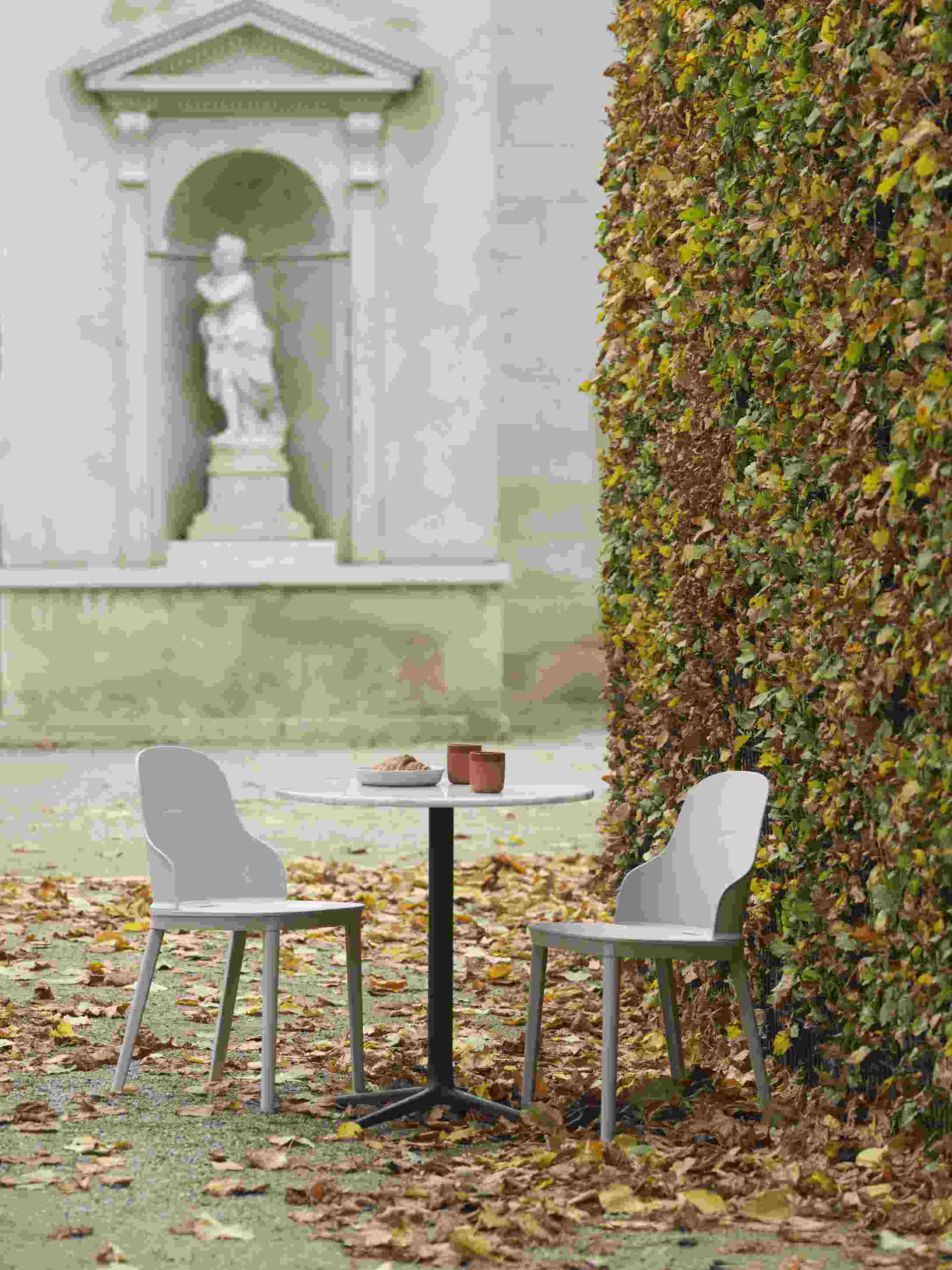Zwei graue Allez Chair PP Stühle von Normann Copenhagen mit Tisch im herbstlichen Garten.
