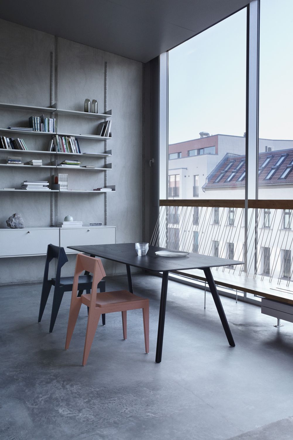 MEYER Tisch Large OUT Esstisch aus Holz, schwarze Tischplatte mit zwei Stühlen in modernem Interieur.