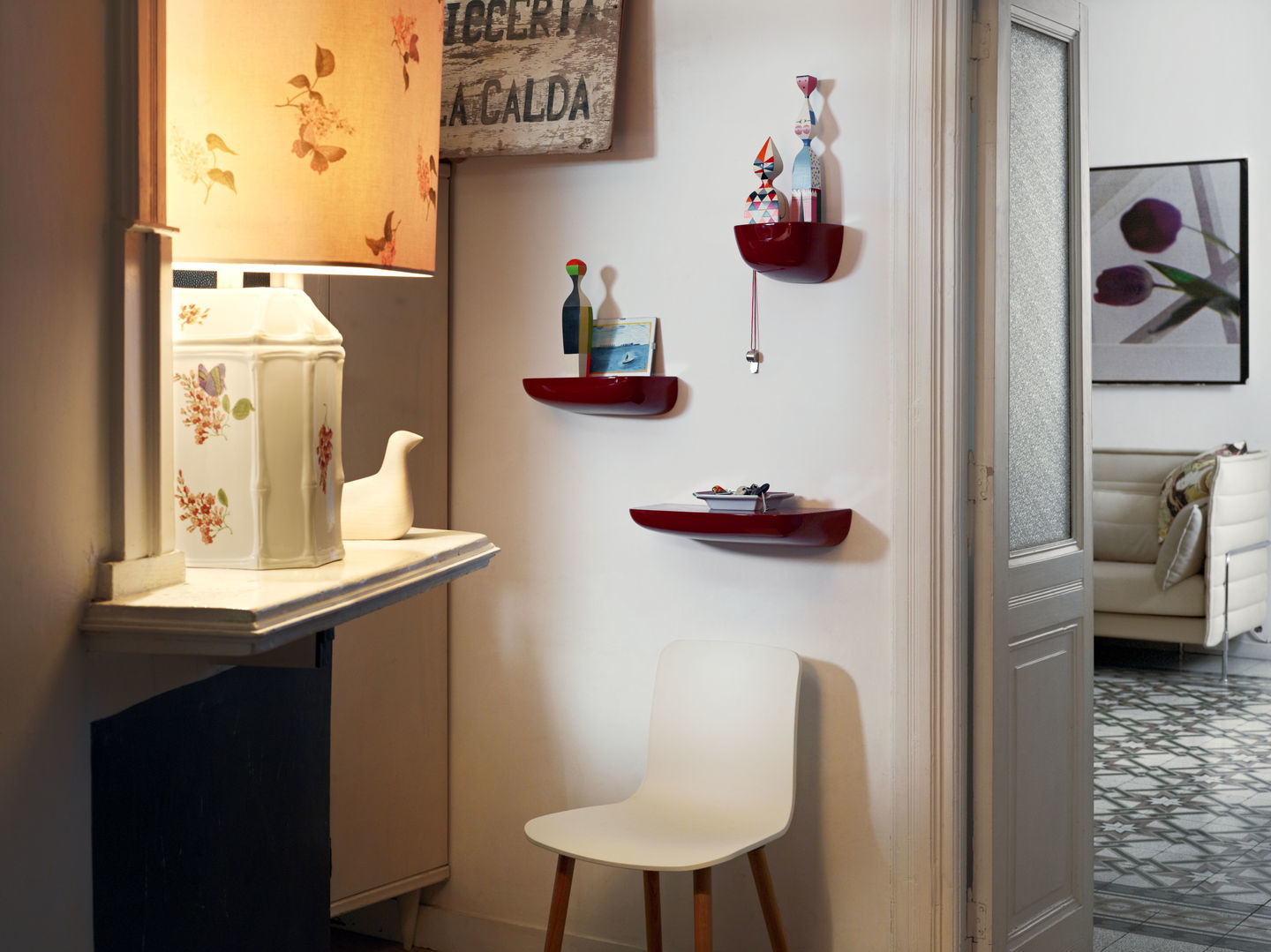 Nahaufnahme von drei roten Corniches Wandboards von Vitra an einer weißen Wand im Flur.