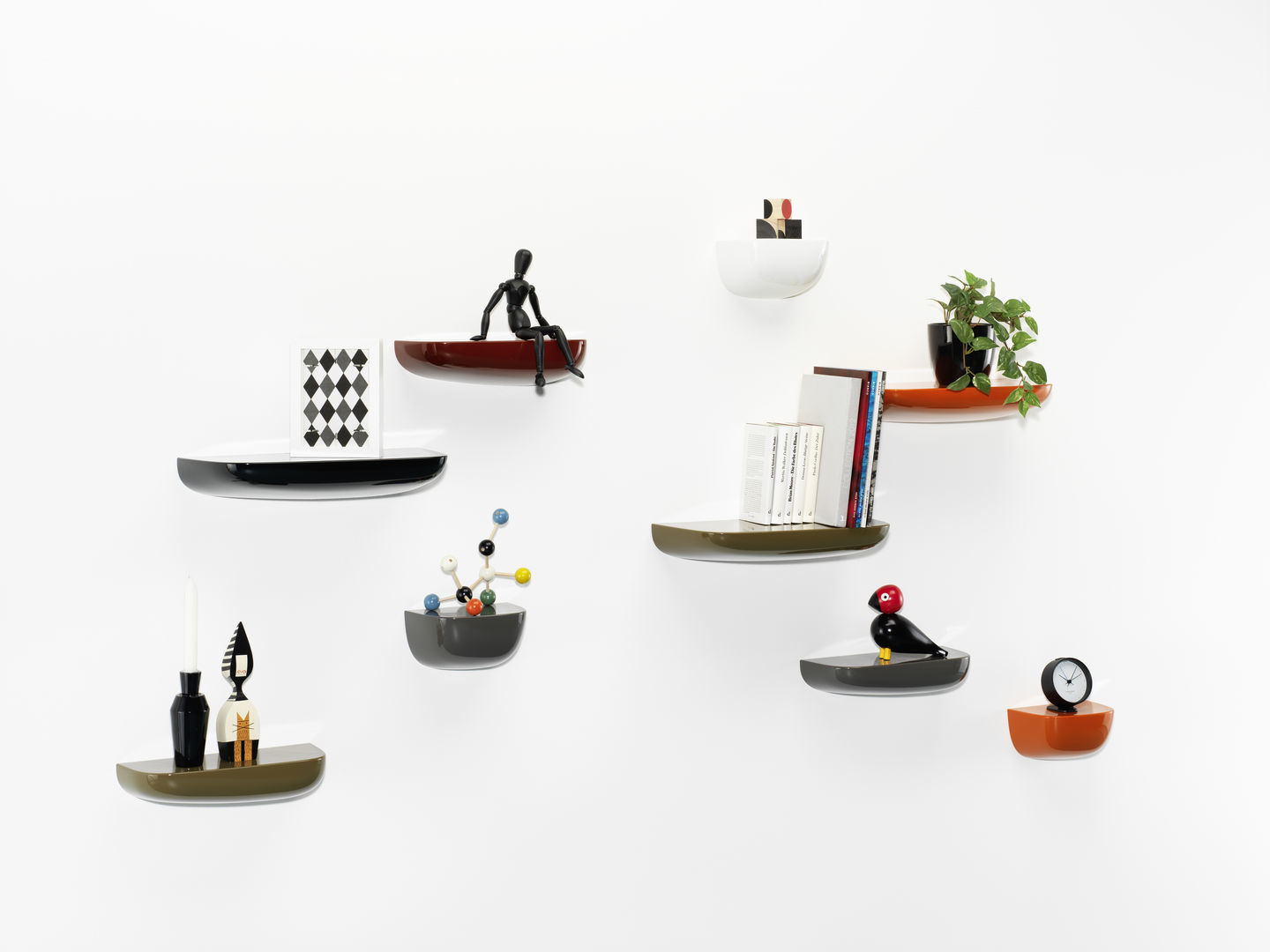 Mehrere Vitra Corniches Wandboards in verschiedenen Farben an einer weißen Wand mit Deko.