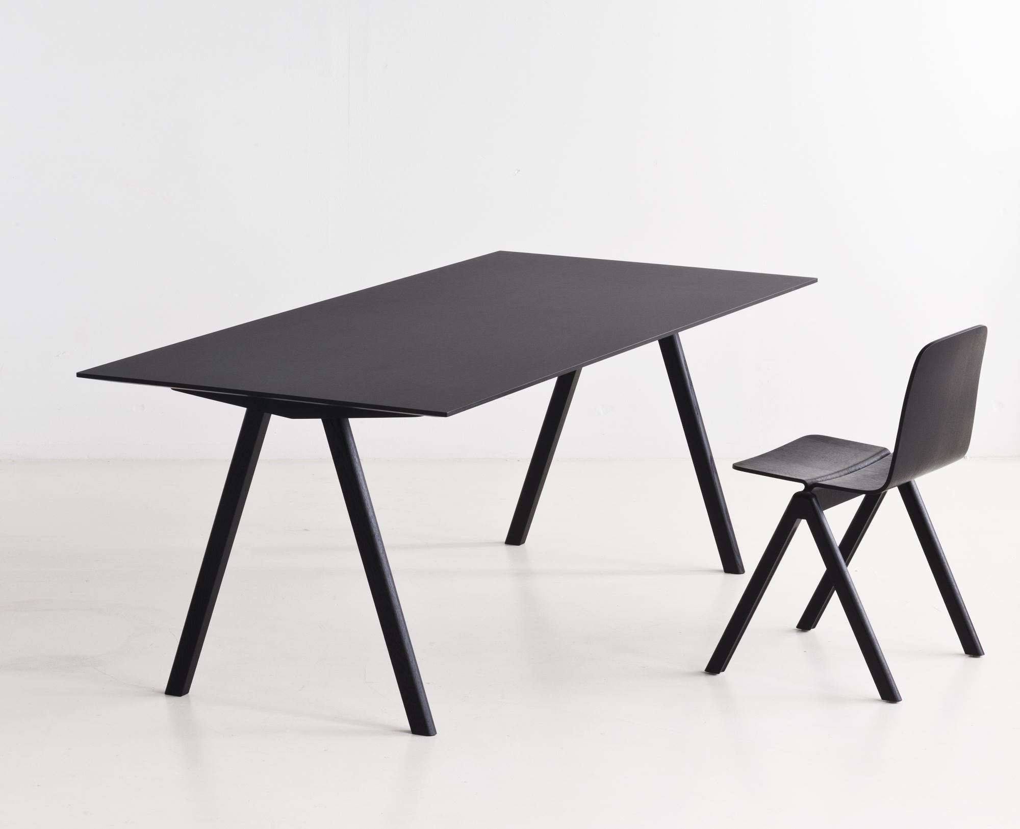 Schwarzer Copenhague Table CPH 10 Tisch von Hay mit passendem Stuhl vor weißem Hintergrund.