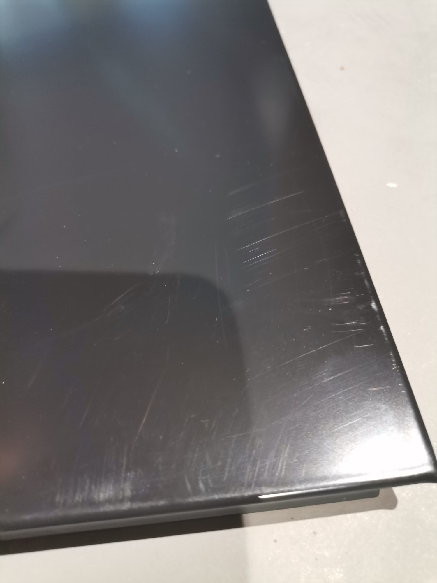 Detailaufnahme einer schwarzen USM Haller Tischplatte mit Kratzern, ein Mängelexemplar für Ersatzteile.