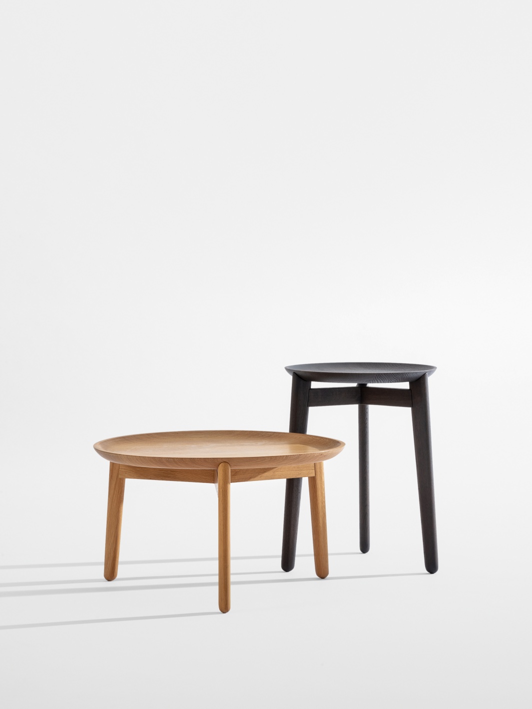 Plaisir Beistelltisch von Zeitraum: Zwei runde Holztische in Eiche, hell und dunkel, minimalistisches Design.