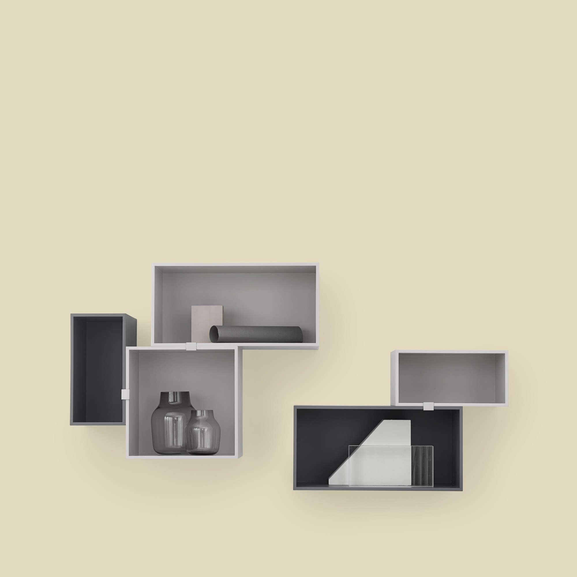 Muuto Mini Stacked Regalsystem 2.0: Wandregal mit grauen Boxen in verschiedenen Größen und Anordnungen.