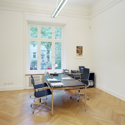 USM Haller Tisch 175x75 cm in stilvollem Büro mit Parkettboden und Bürostuhl, ideal für modernes Arbeiten.