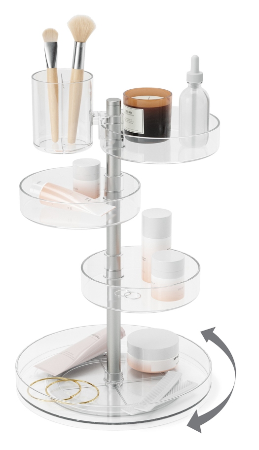 Umbra Pirouette Organizer mit Kosmetikprodukten, Make-up-Pinsel und Schmuck auf transparenten, drehbaren Ablagen.