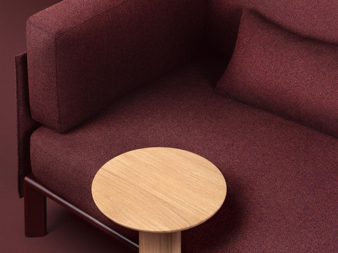Anagram Anstecktisch von Vitra, runde Tischplatte aus hellem Holz, passend zum modernen Sofa.