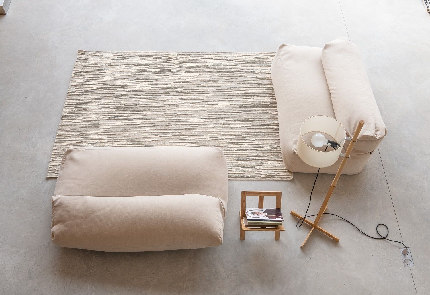Nanimarquina Doblecara Rug Teppich in Beige, kombiniert mit Sitzmöbeln und Stehlampe für ein modernes Wohnambiente.