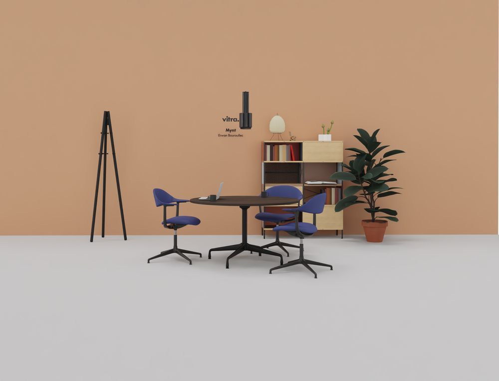 Vitra Mynt Bürodrehstühle mit blauer Polsterung um einen runden Tisch in einem modernen Büro.