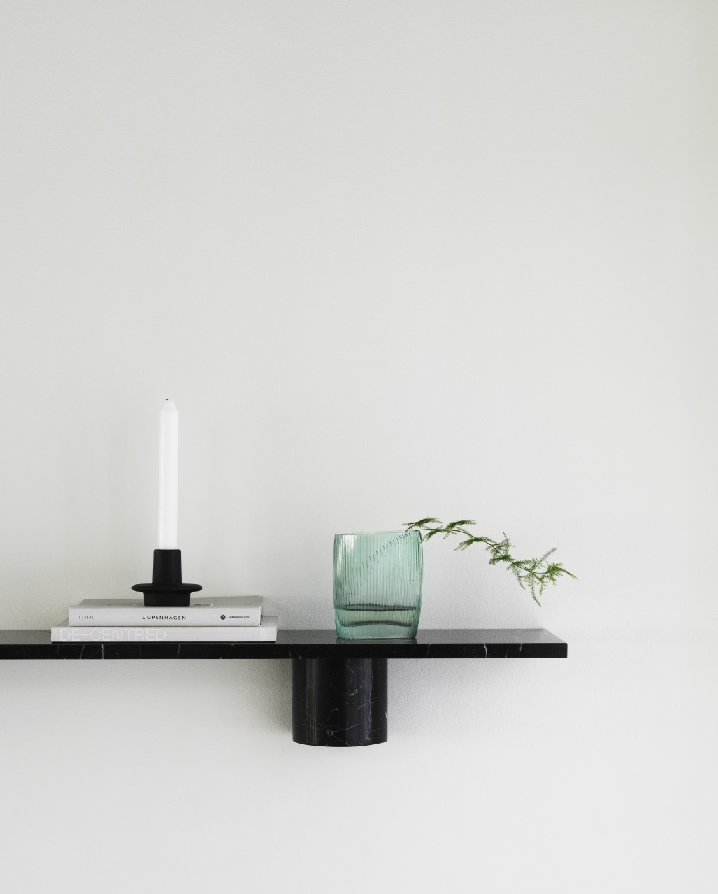 Schwarzes Sten Regal von Normann Copenhagen mit Deko: Kerze, Bücher und Glasvase.