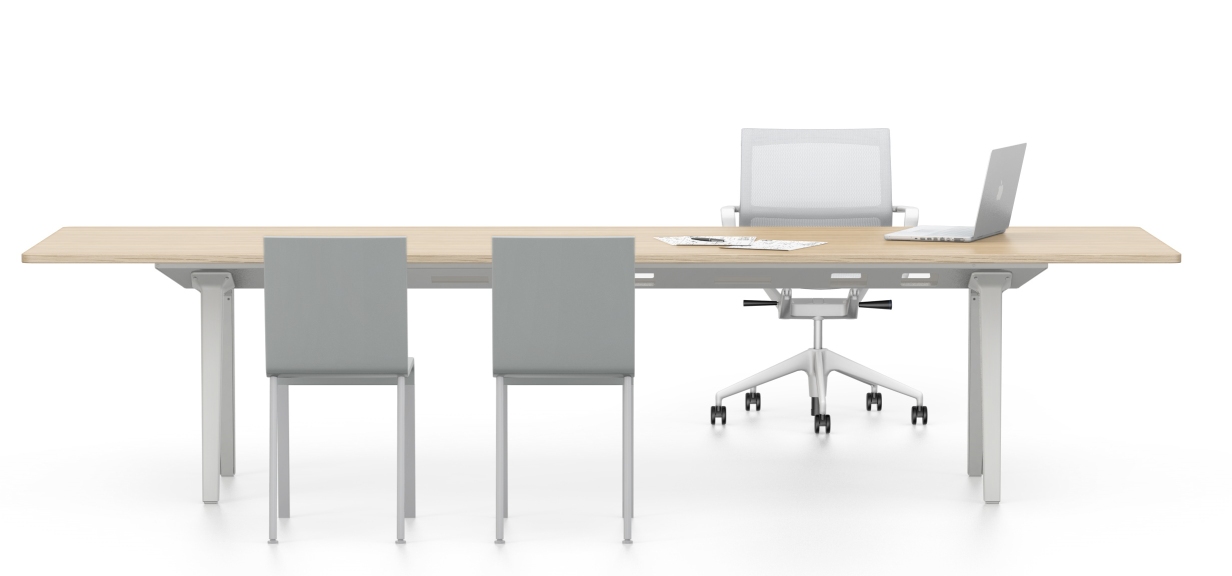 Physix Bürodrehstuhl von Vitra mit hellem Holztisch, zwei Stühlen und Laptop im modernen Büro.