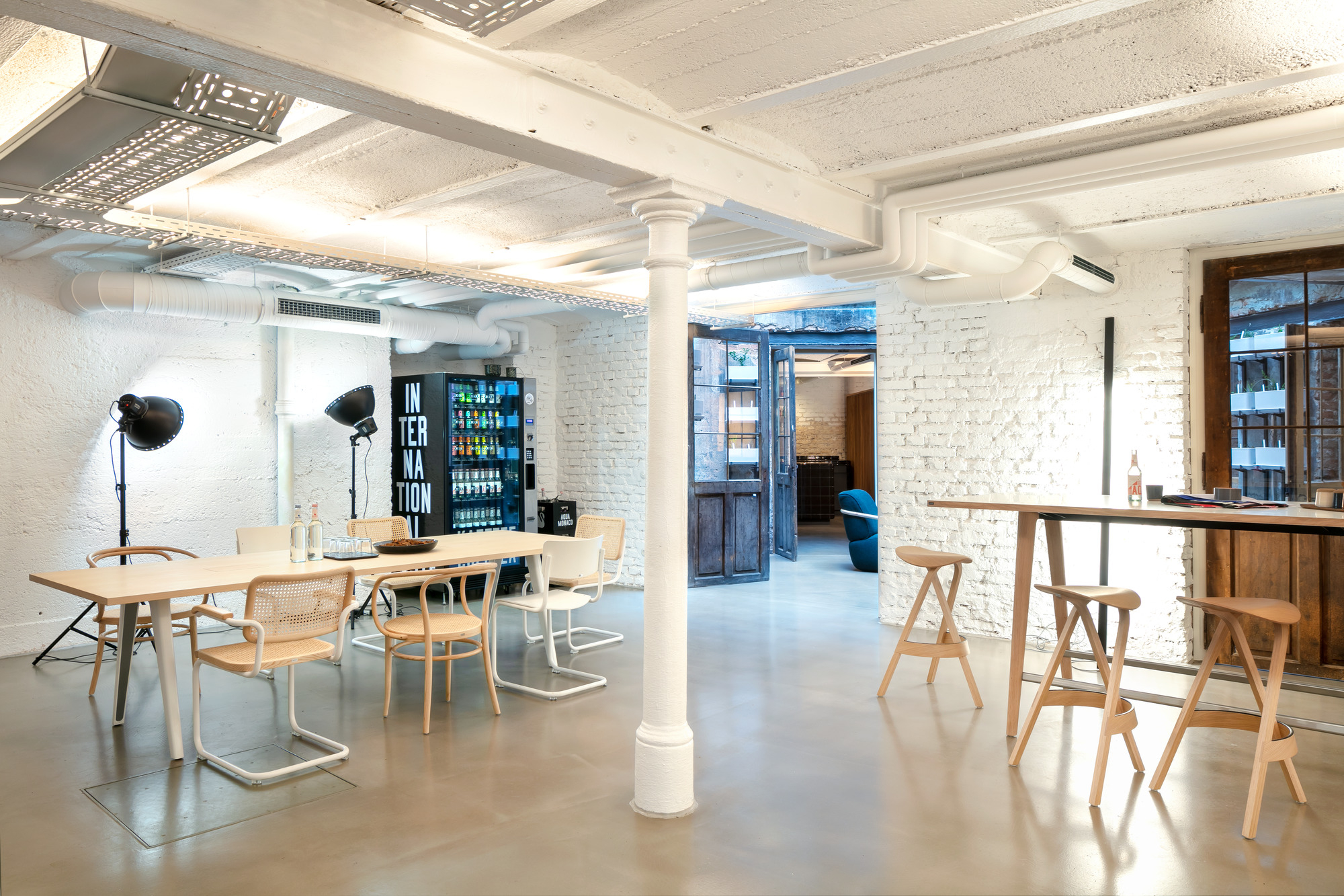 Heller Raum mit Thonet 1500 Tisch, Stühlen und Barhockern, ideal für moderne Büros und Konferenzräume.