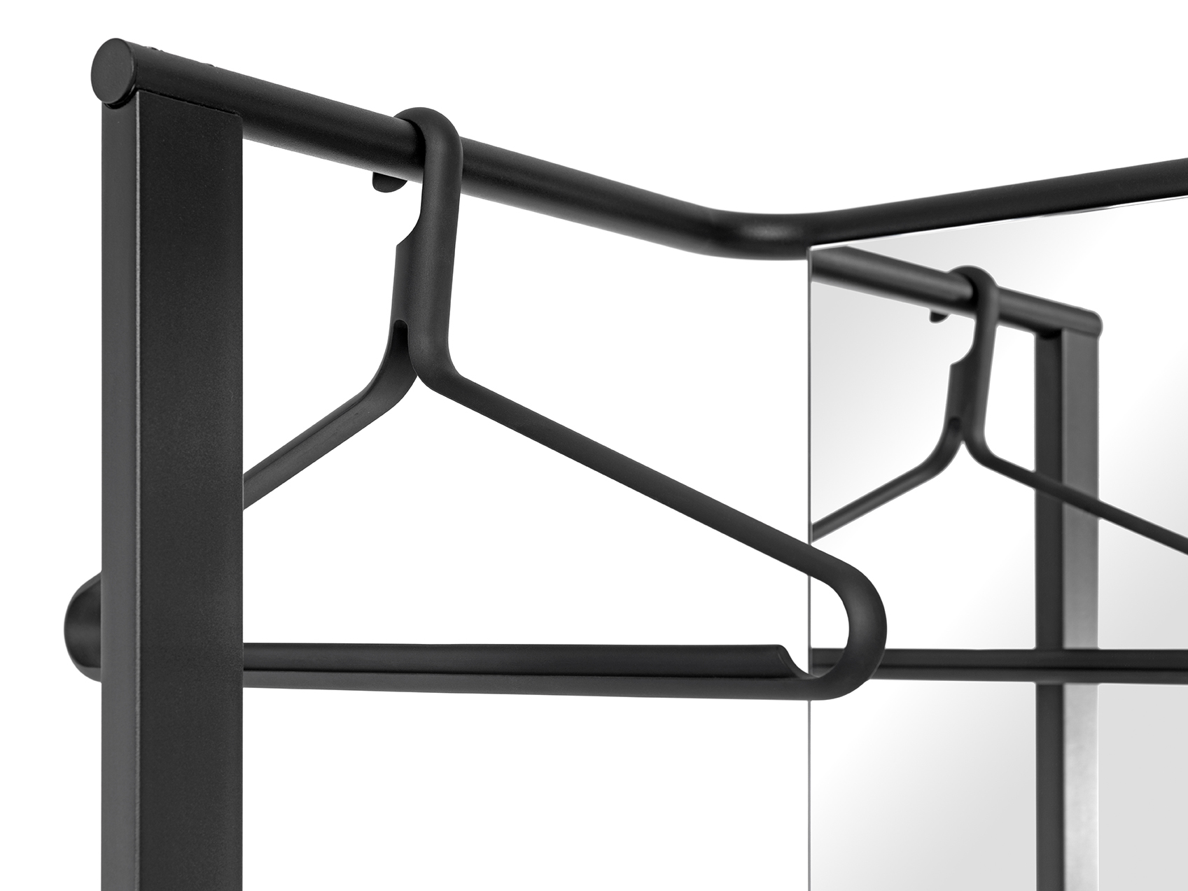 Schwarzer Schönbuch Kleiderbügel "Angle" an einer Kleiderstange mit Spiegel im Hintergrund. Modernes Design für Garderobe.