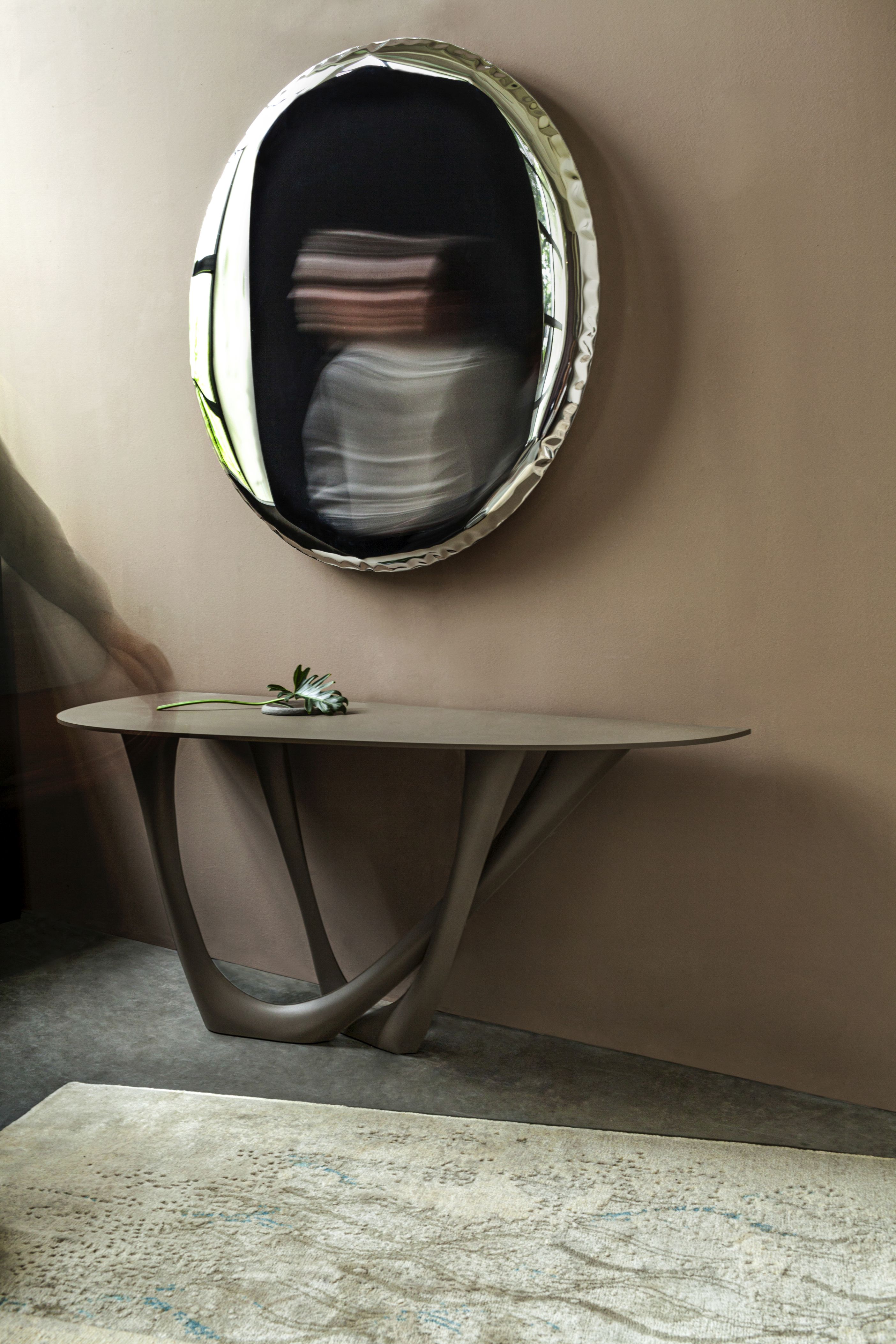 Oko Inox Spiegel von Zieta über Konsole mit Blume, modernes Interior Design.