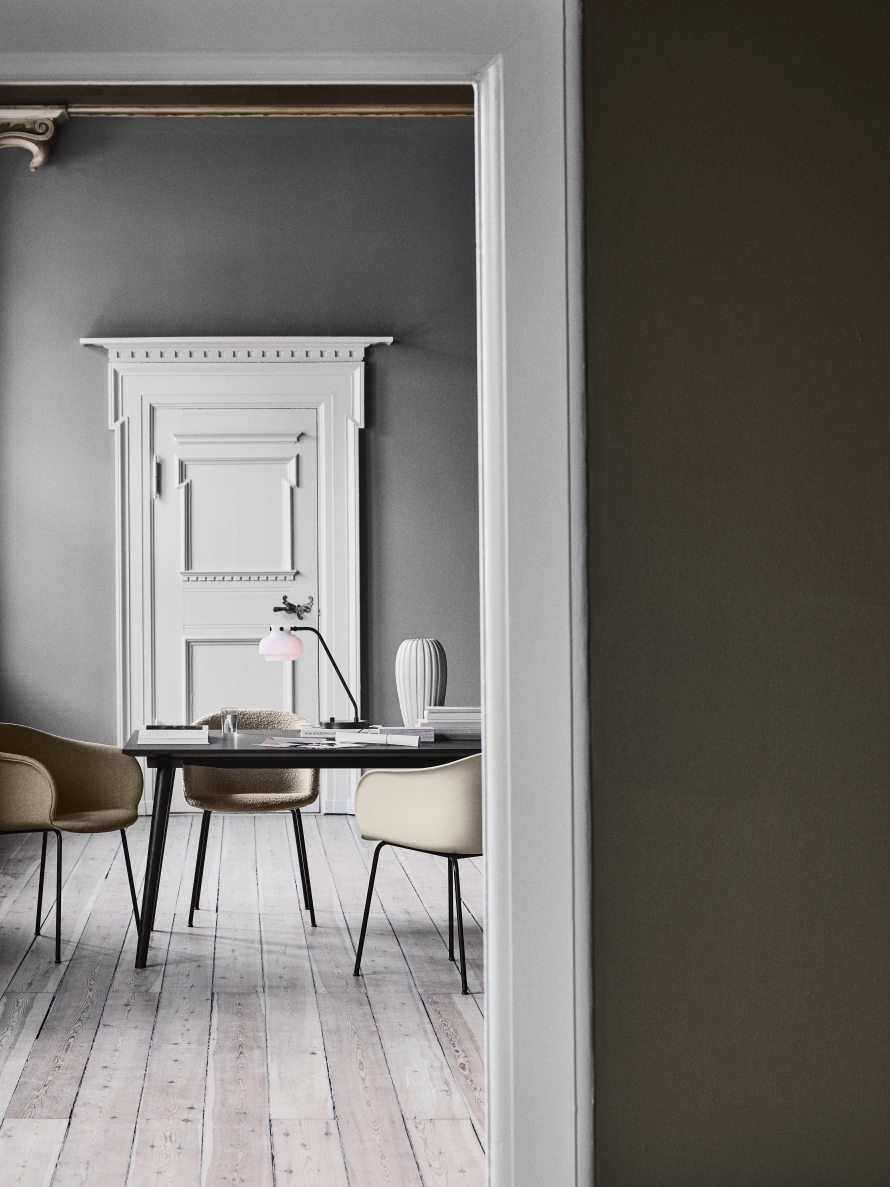 AndTradition In Between Tisch SK5/SK6 mit Stühlen und Lampe in einem stilvollen, modernen Interieur.