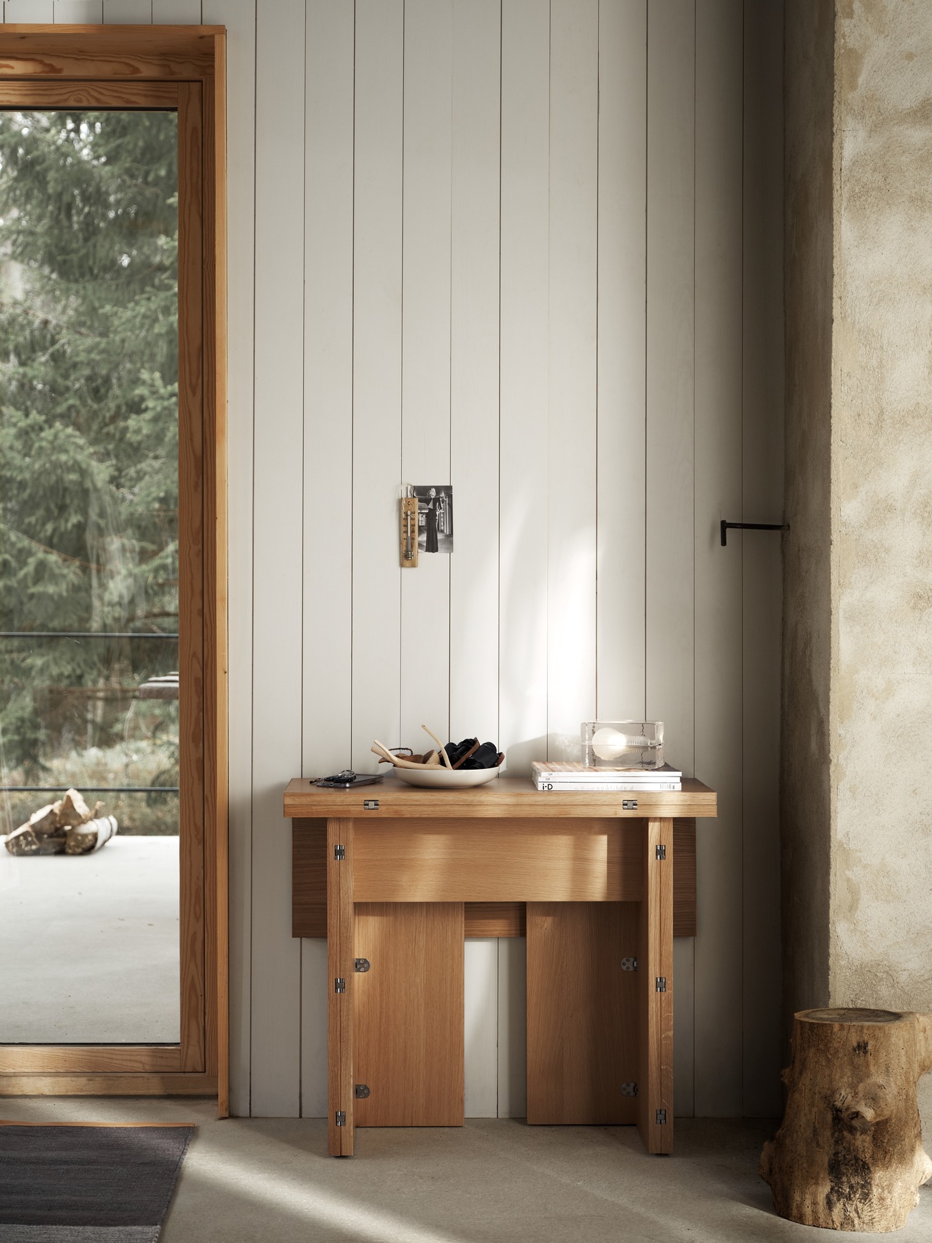 Design House Stockholm Flip Table Klapptisch aus Eichenholz, halb ausgeklappt, mit Deko-Elementen in modernem Interieur.