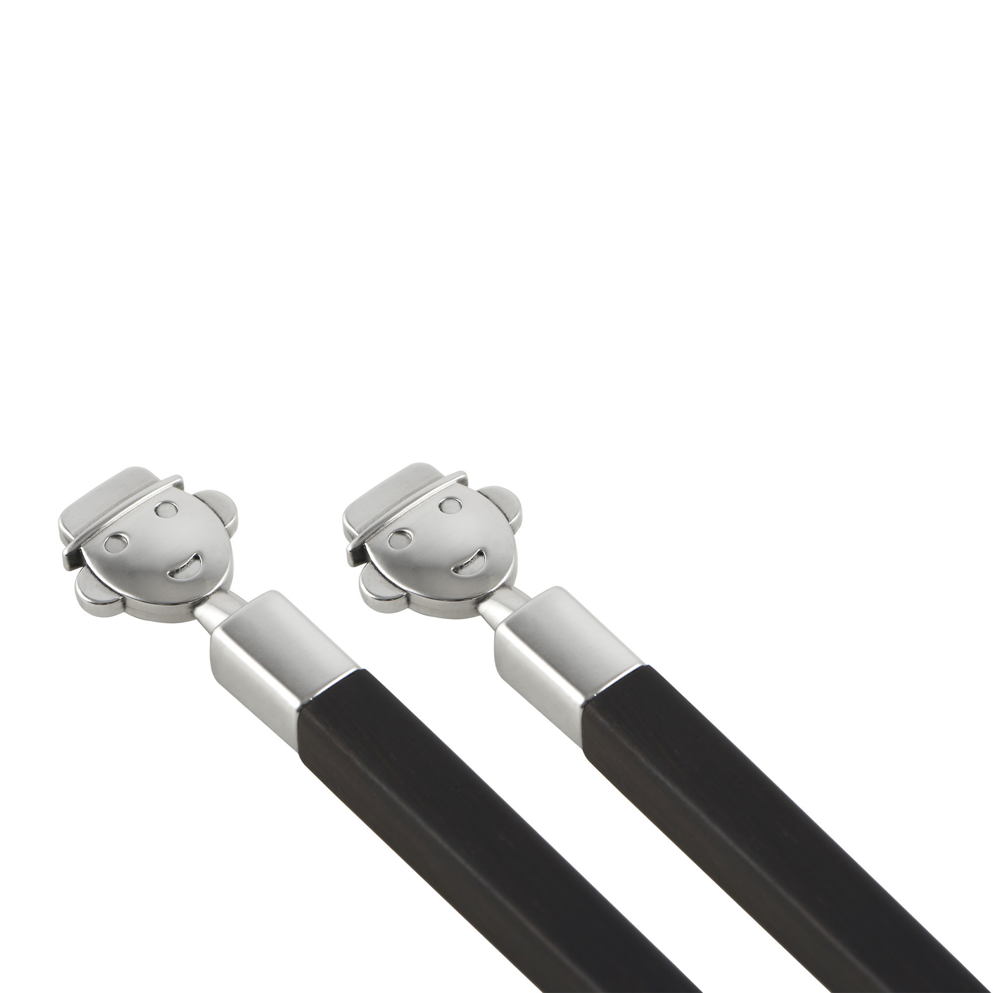 Zwei Alessi Anna Stick Essstäbchen mit silberfarbenem Gesicht und schwarzem Griff, stilvolles Küchenaccessoire.