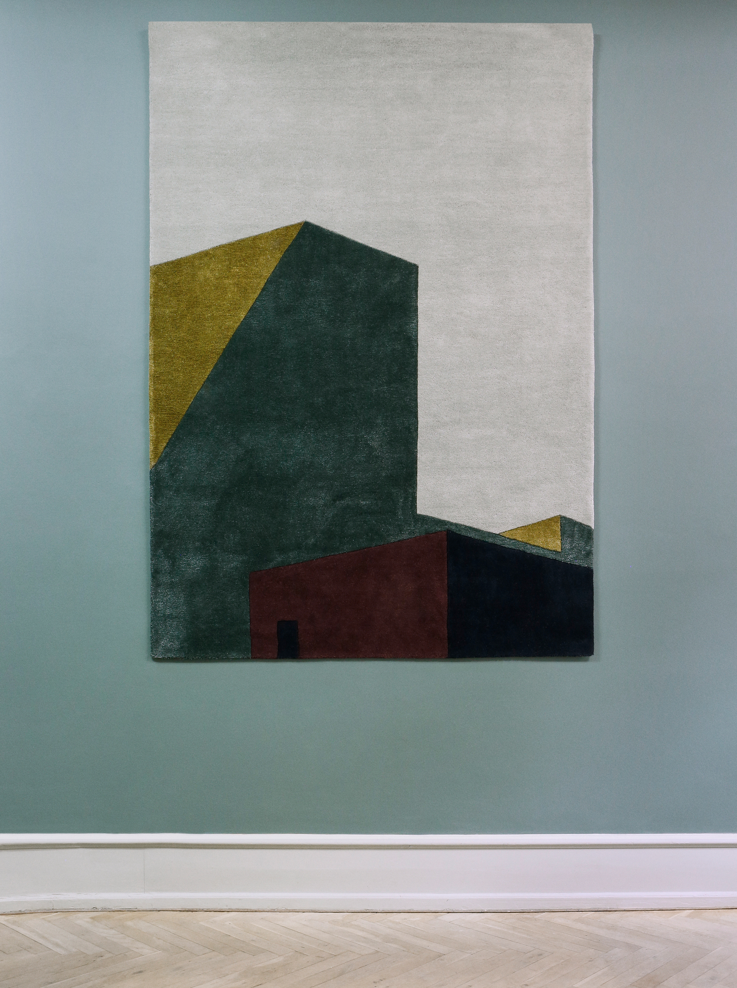 Arqui Teppich 300x200 von Please Wait to be Seated mit abstraktem, geometrischem Muster in Grün, Gold und Rot.