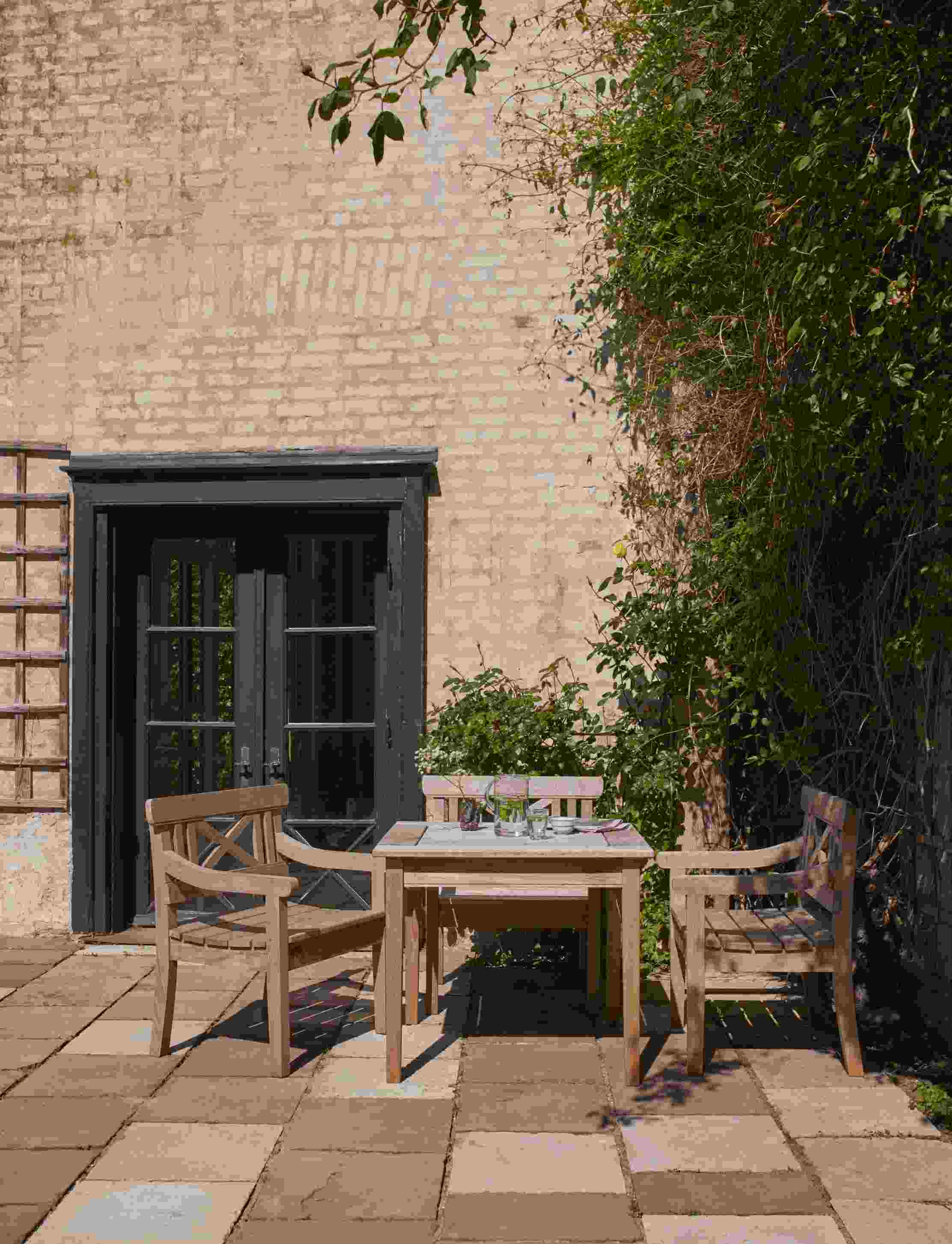 Drachmann Stuhl und Gartentisch Set von Skagerak by Fritz Hansen auf einer Terrasse.