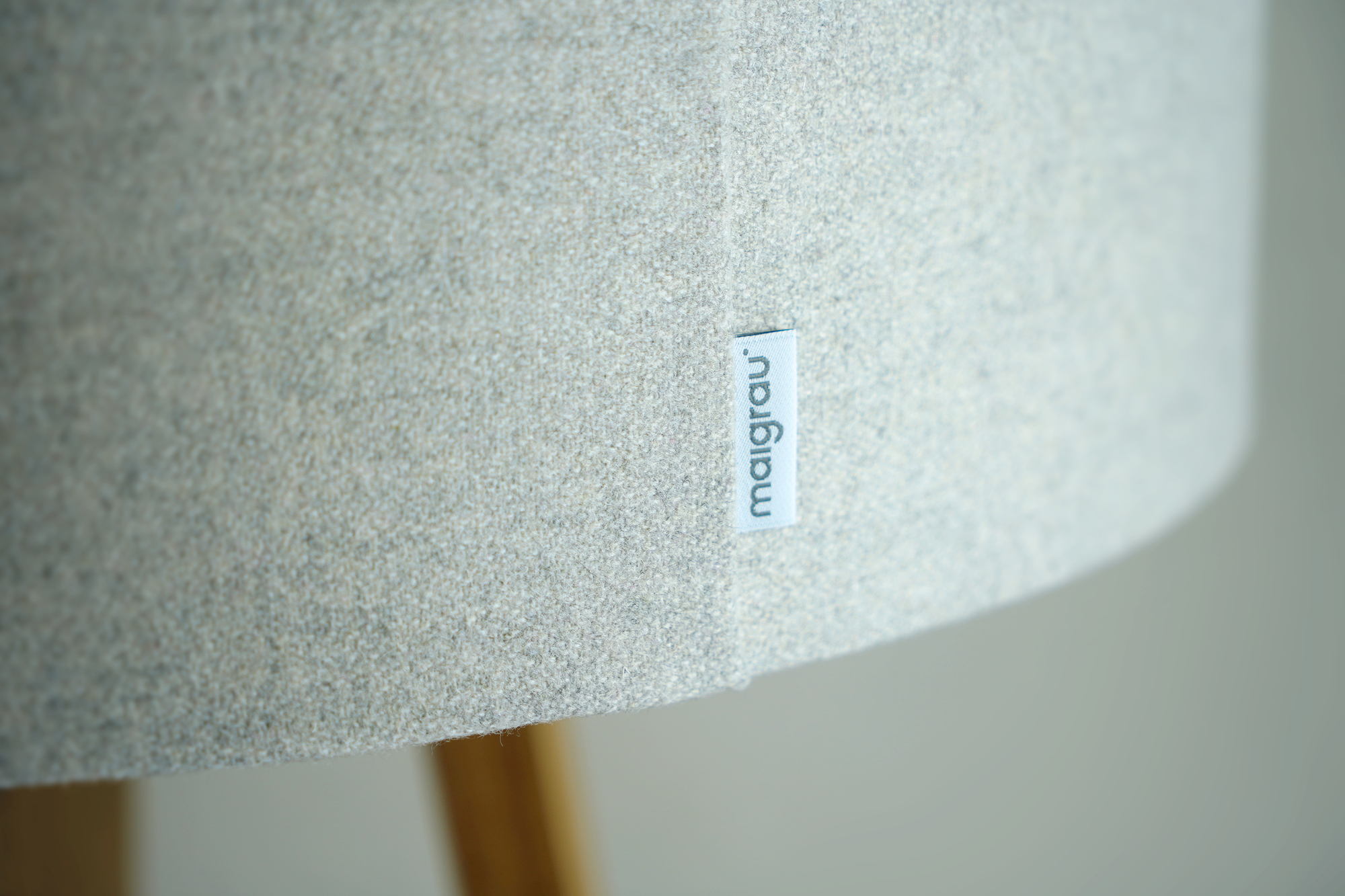 Detailaufnahme des Lampenschirms der Luca Stehleuchte von Maigrau mit Stoffstruktur und Markenlabel.