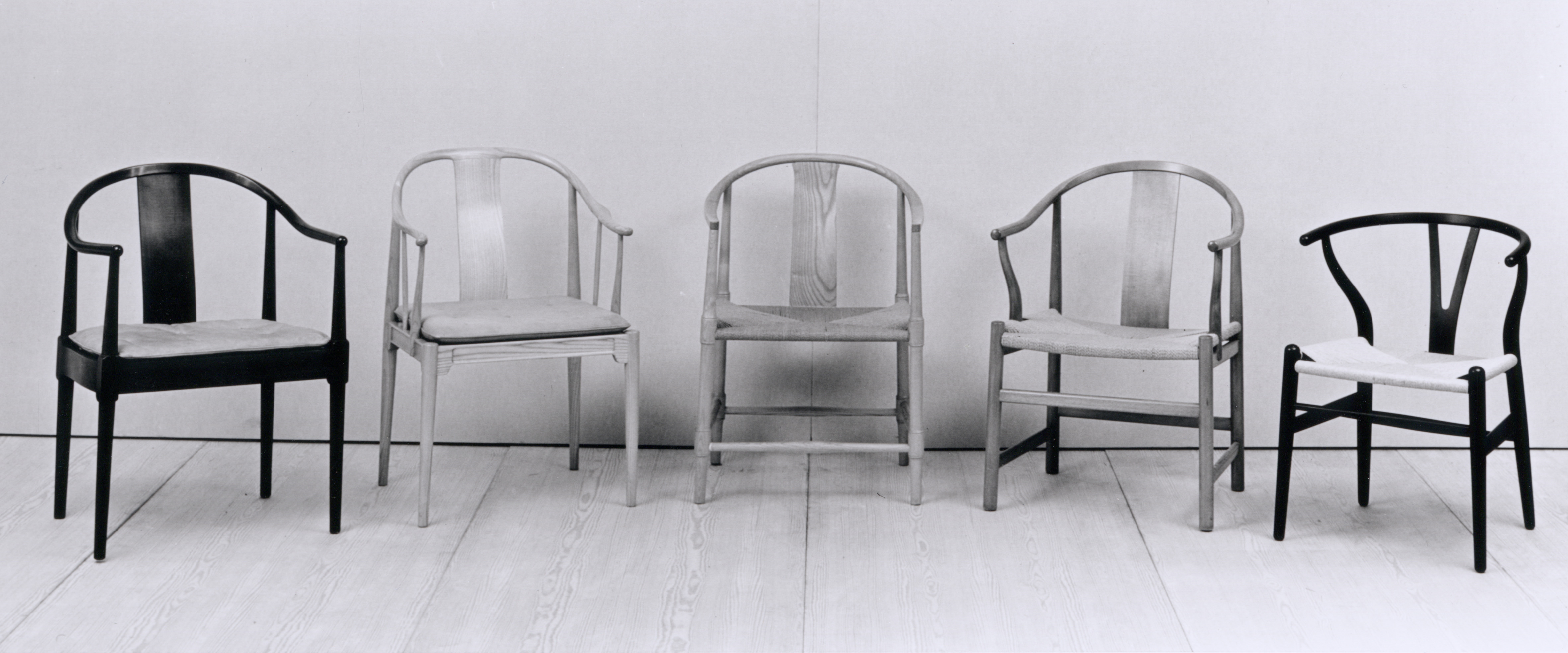 Schwarz-weißes Foto von fünf verschiedenen China Stühlen von Fritz Hansen mit unterschiedlichen Designs und Materialien.