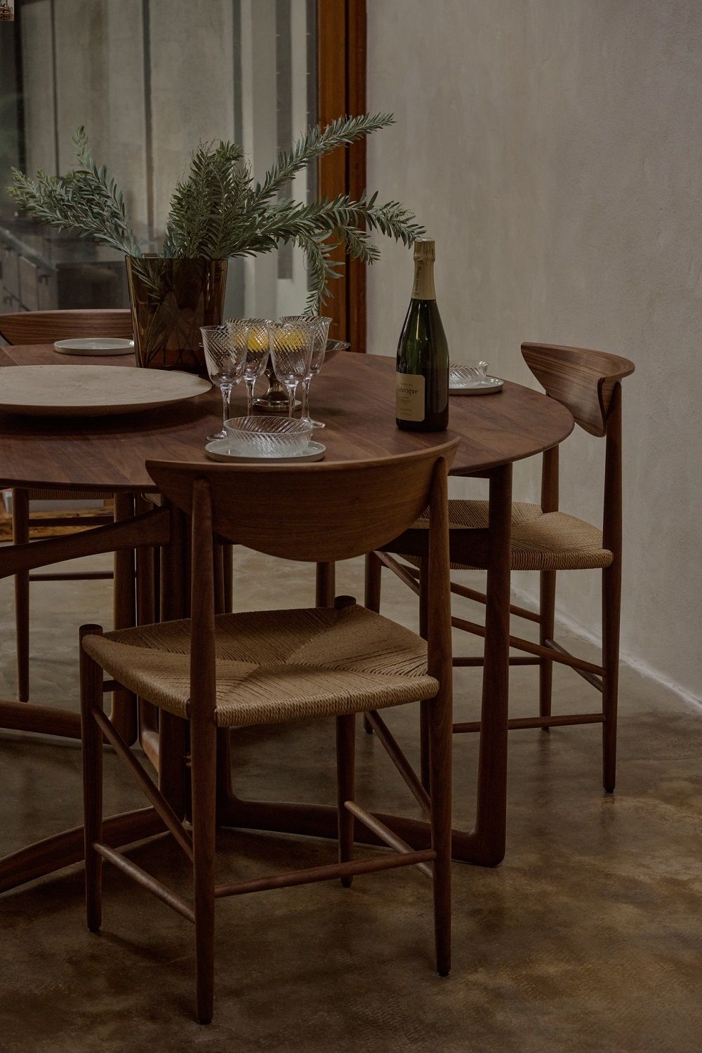 AndTradition Drop Leaf HM6 Esstisch aus Holz mit Stühlen, Champagner und Dekoration für ein stilvolles Esszimmer.