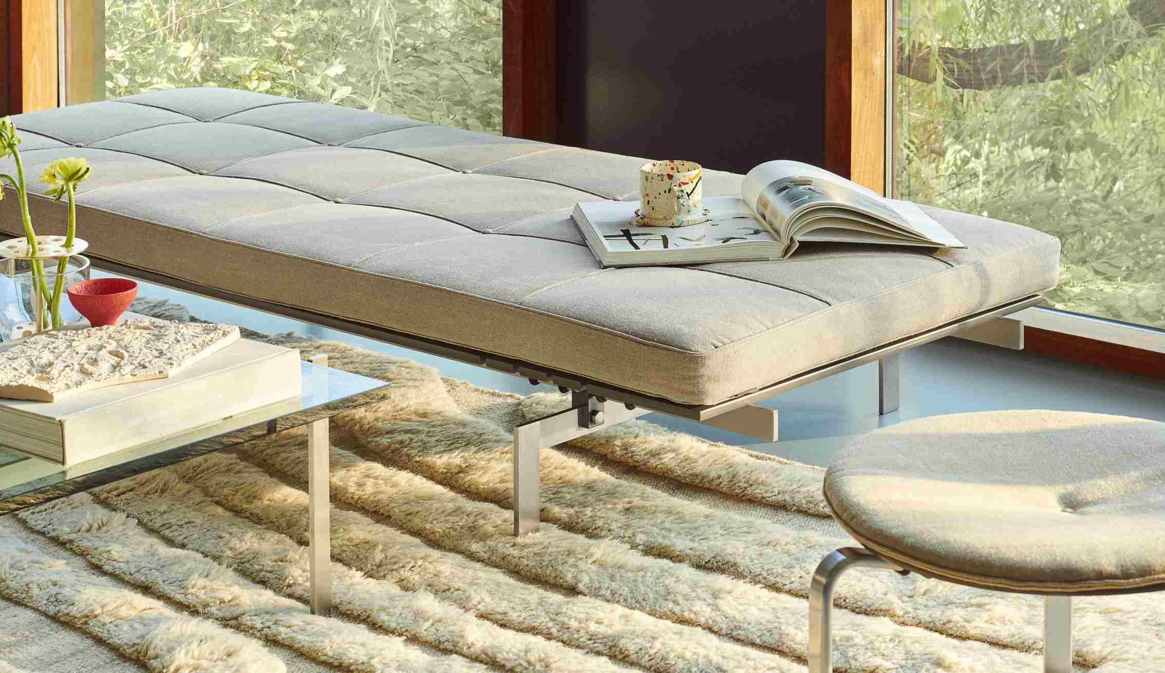 Helle Inneneinrichtung mit Fritz Hansen PK80 Liege, Teppich und Beistelltisch für entspannte Momente.